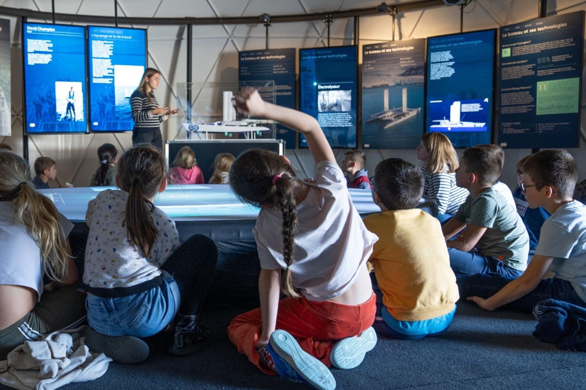 Kid raising hand during a conference